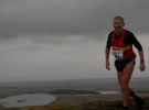 Andy Spenceley on the wind blown summit of West Lomond, Leg3