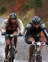 A mud covered Nathan Beard (left) at end of cycle leg