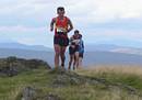 Stewart Whitlie leading Ken Richmond to the summit of Dumyat